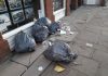 Bags spewing disgusting rubbish blighting major city street